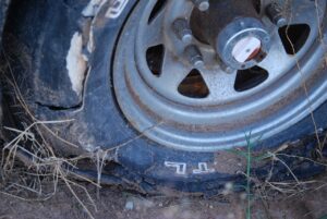 What causes tire feathering?